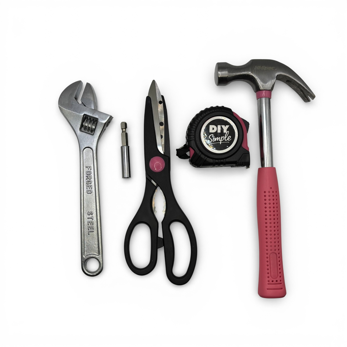 A set of four DIY hand tools on a white background: a silver adjustable wrench, black-handled scissors, a black tape measure labeled DIY Simple, and a hammer with a red handle.